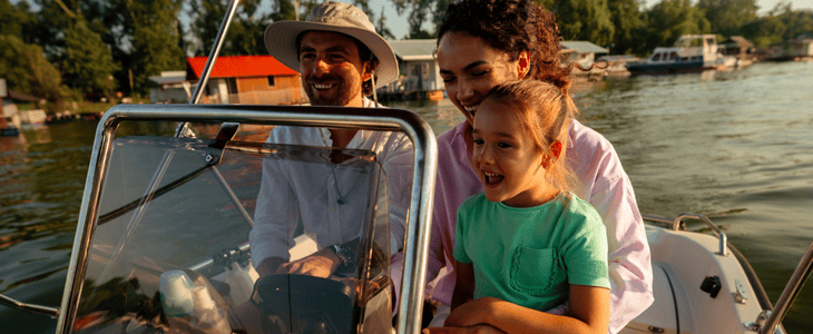 family on lake smiling